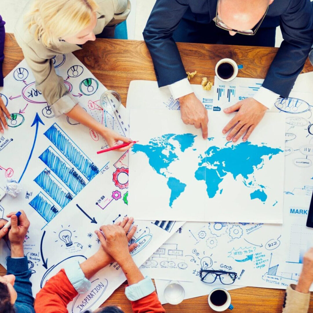 Team collaborating over global business strategies and data charts.