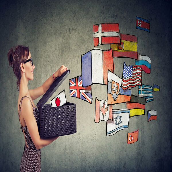 Woman pulling flags from a basket representing international diversity.